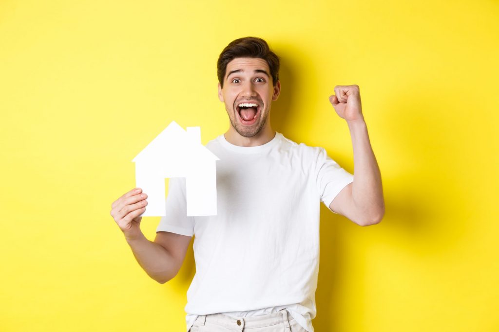 real estate concept cheerful man showing paper ho 2022 12 16 06 12 40 utc