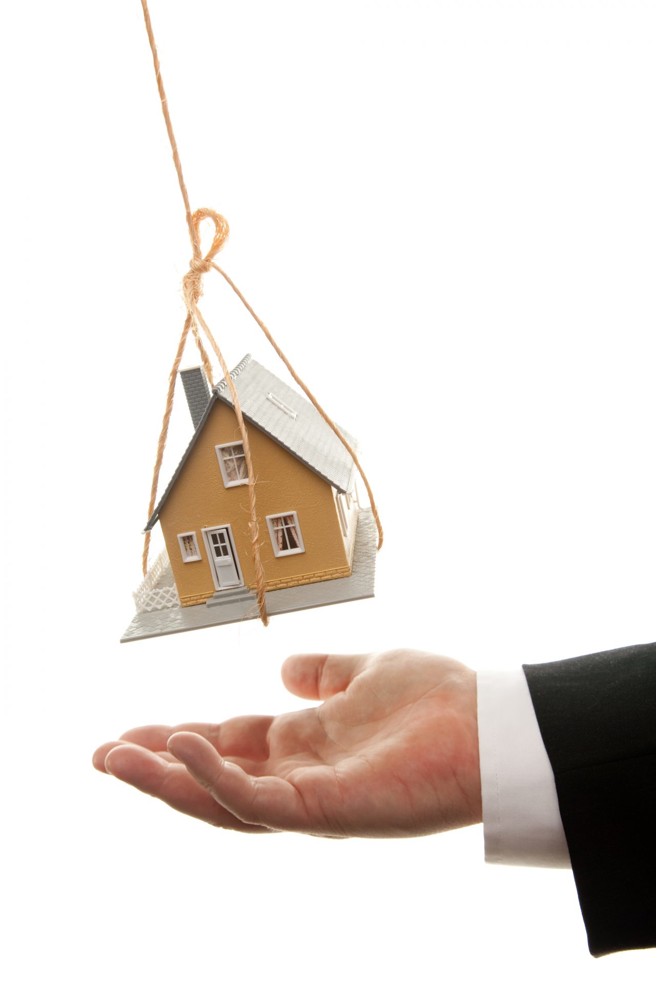 businessman s hand under dangling house 2022 10 17 01 16 55 utc