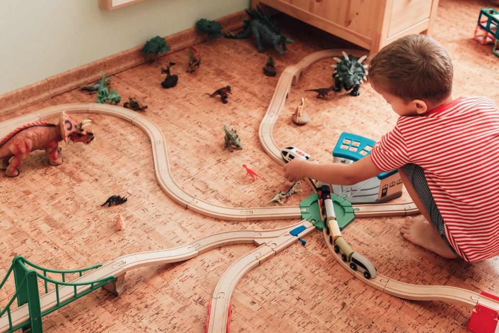 child plays with wooden railroad in his room 2022 11 11 08 52 08 utc