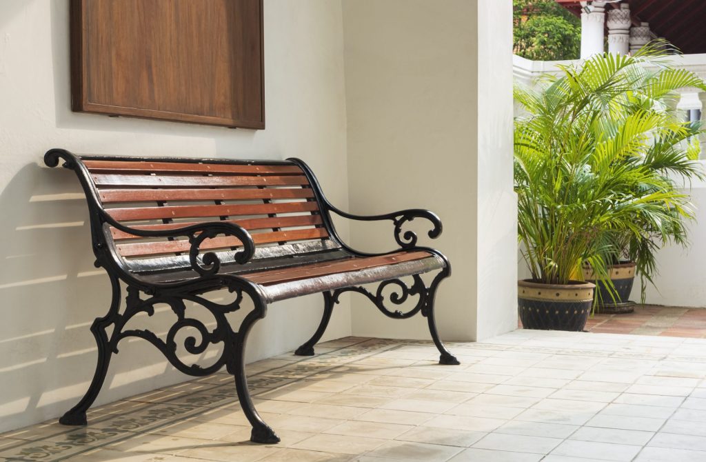 empty vintage bench near white wall with green hou 2023 02 07 21 41 23 utc